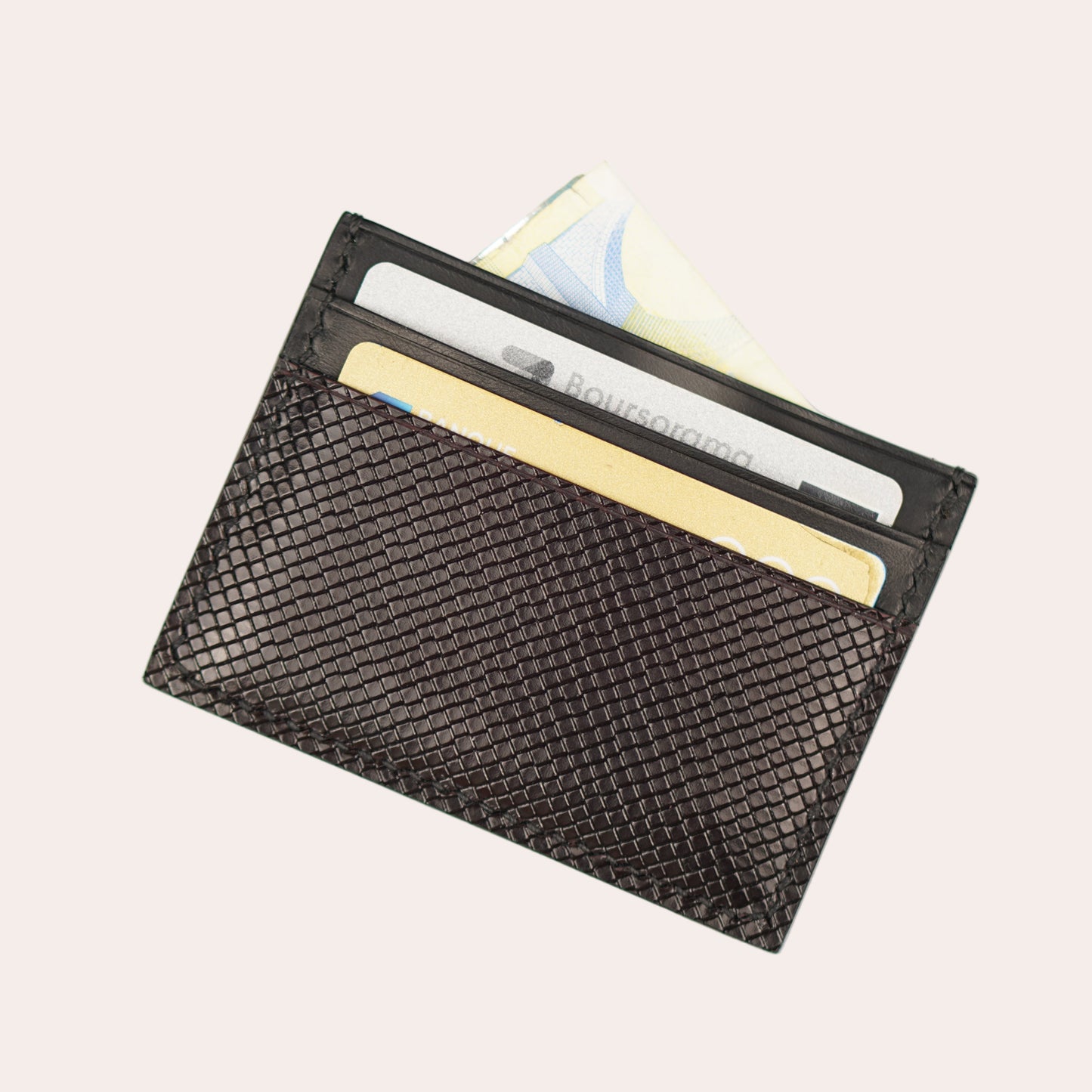 Black mesh cardholder with cards on a light gray background