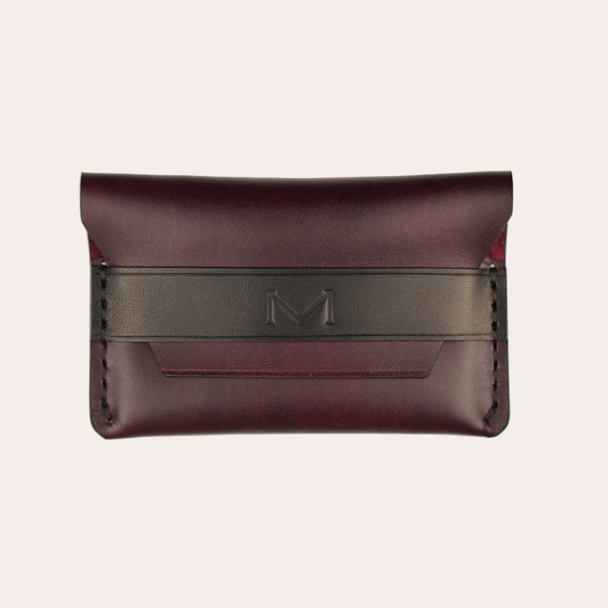 Brown leather wallet with a black strap on a white background
