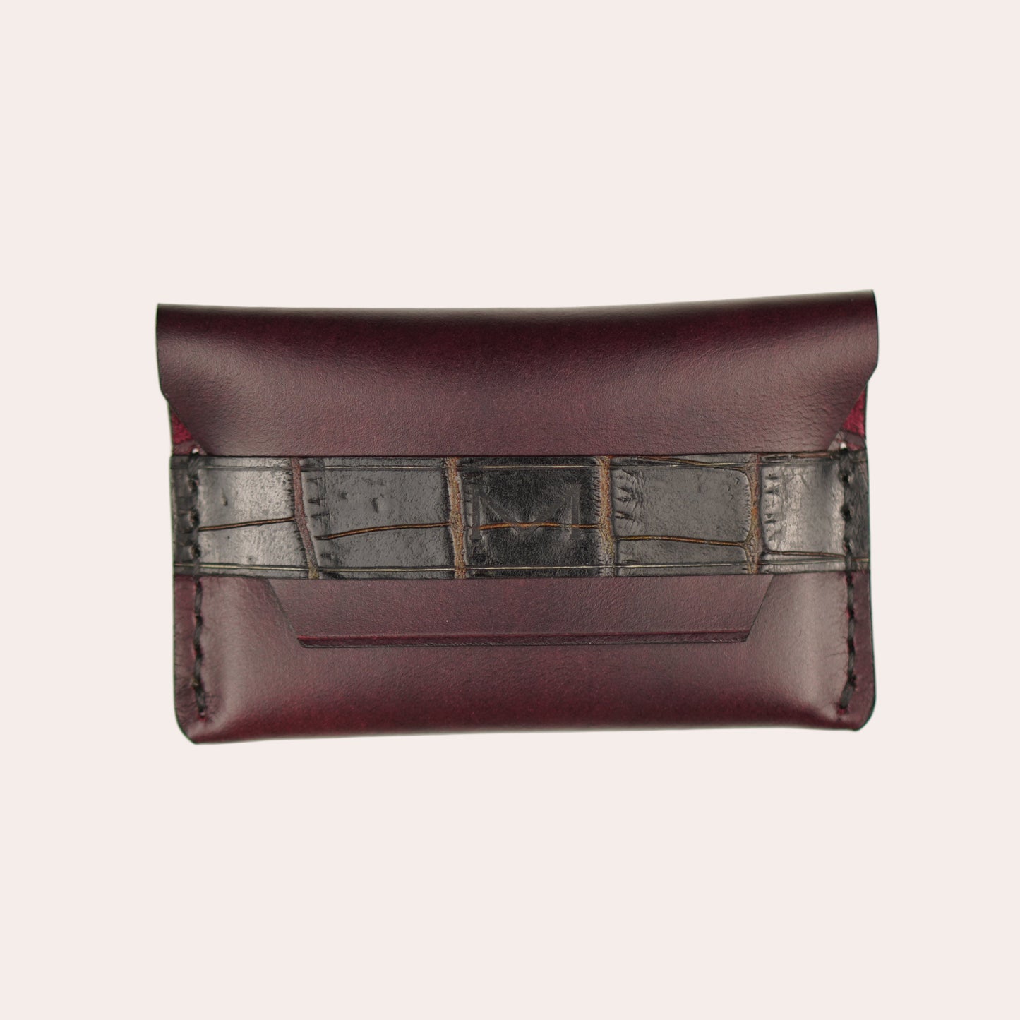Brown leather wallet with metallic accents on a white background