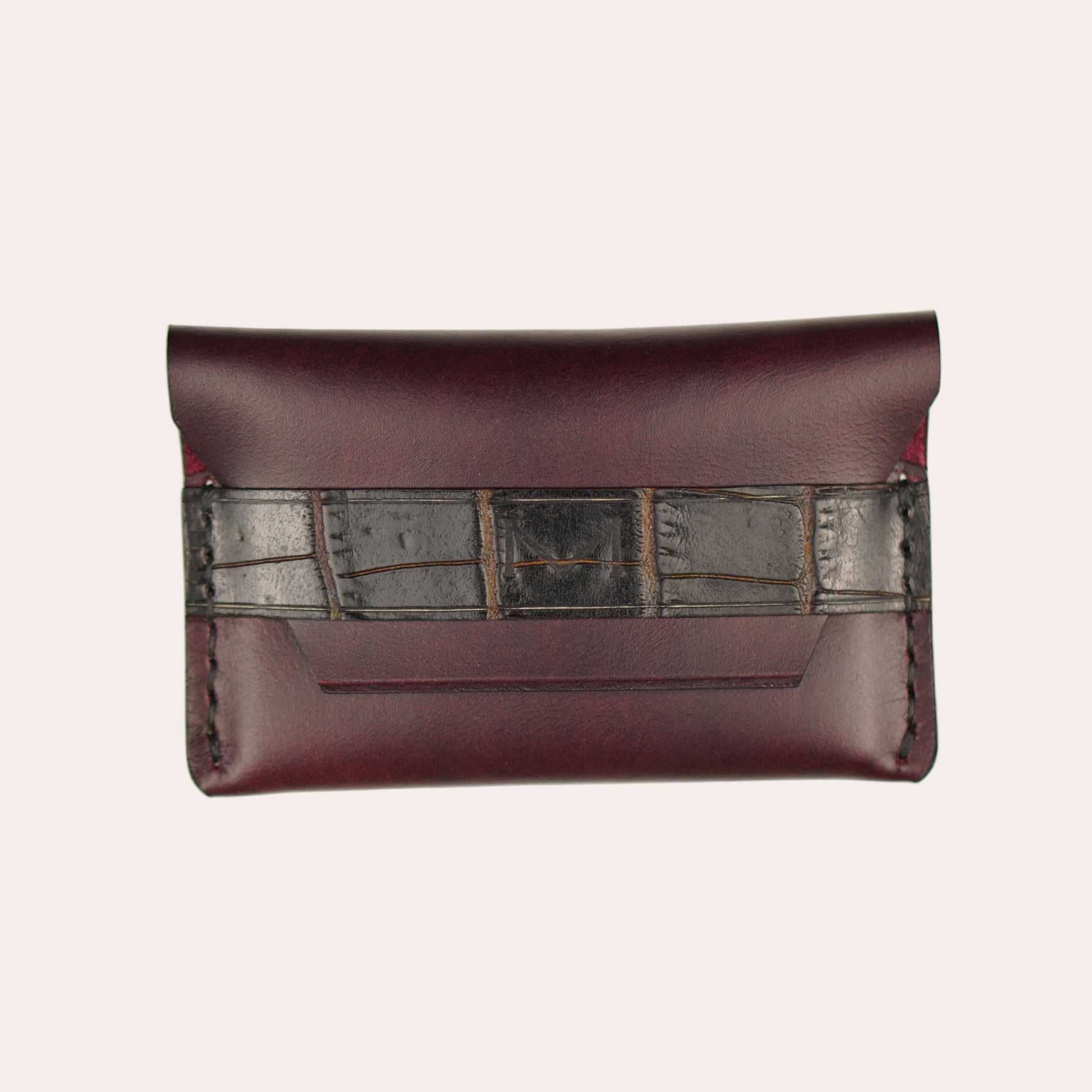 Brown leather wallet with metallic accents on a white background