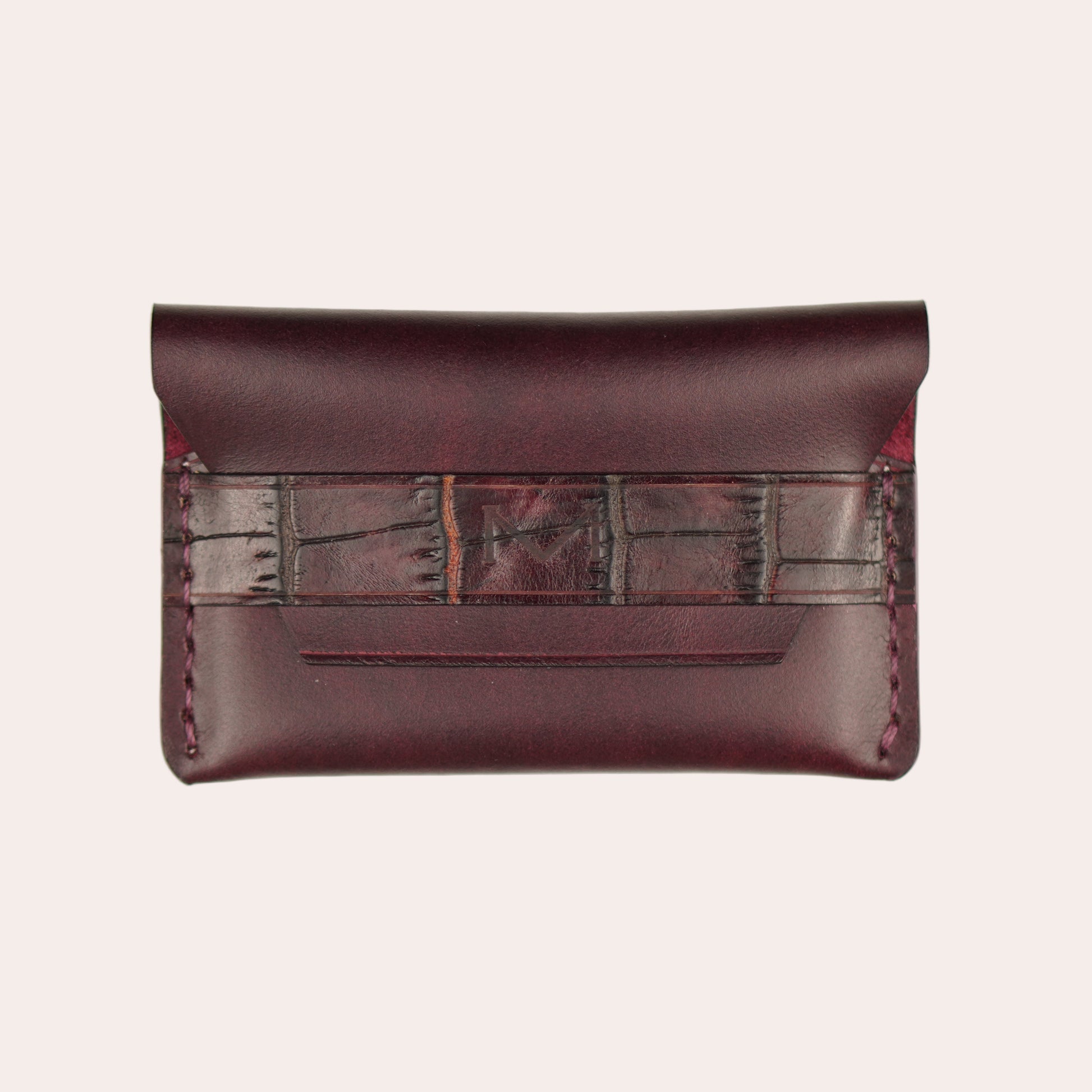 Brown leather clutch bag with a strap on a white background