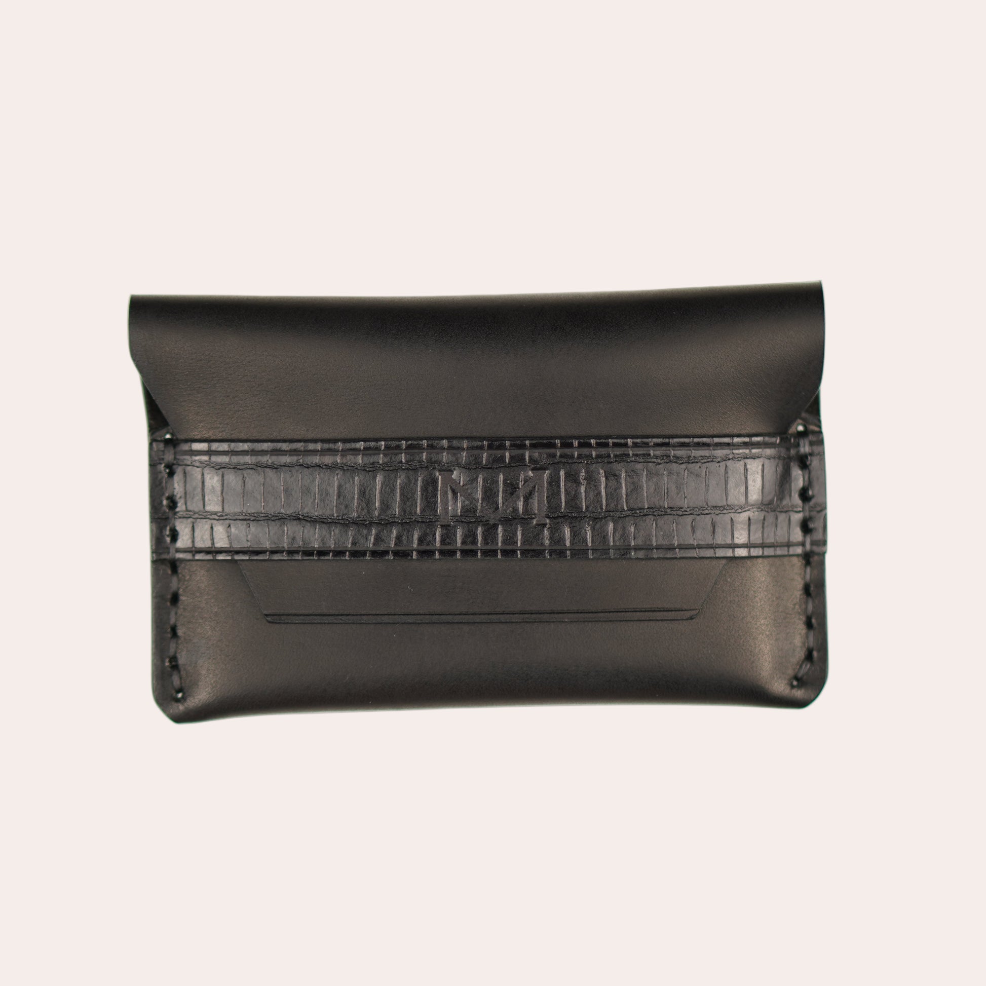 Black leather clutch with textured pattern on a white background