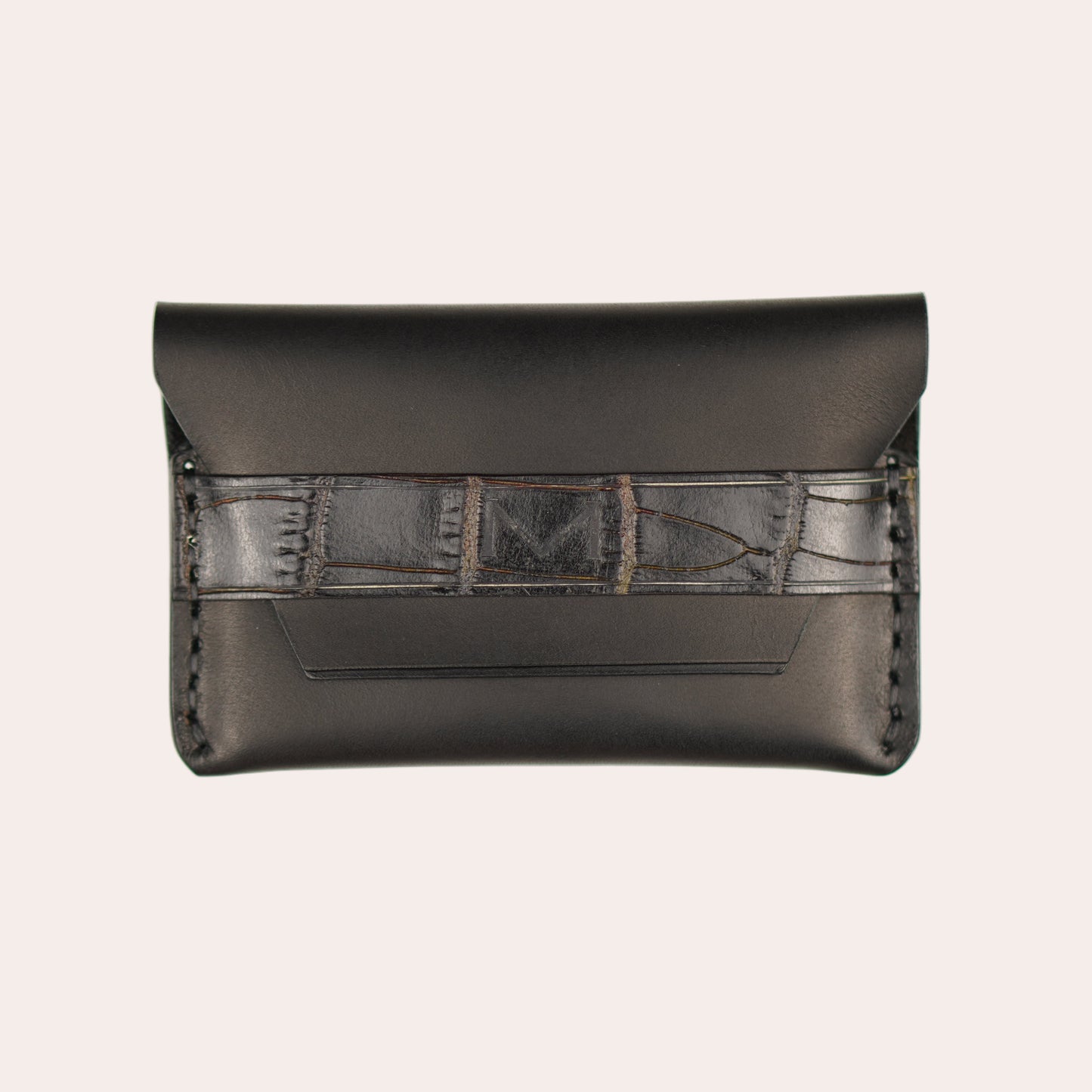 Black leather wallet with geometric pattern on a white background