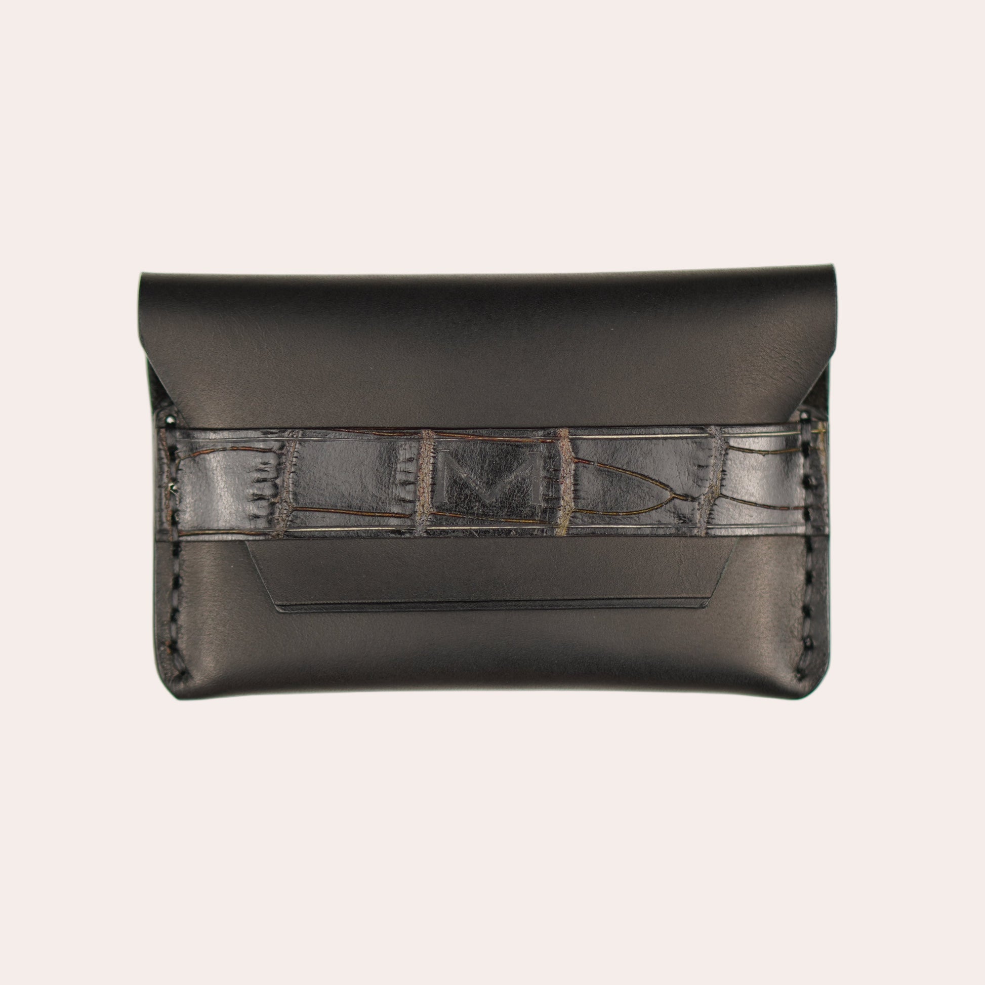 Black leather wallet with geometric pattern on a white background