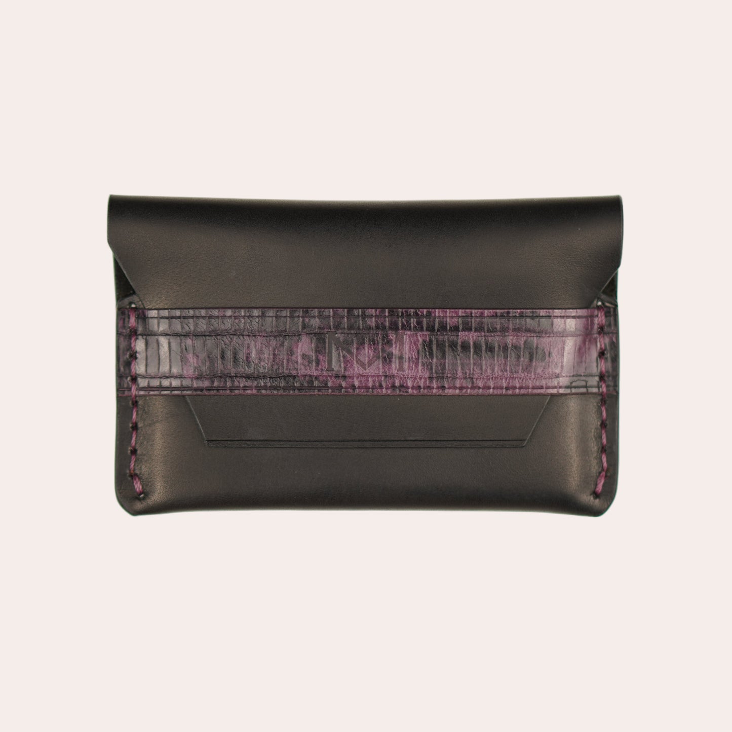Black leather wallet with purple interior lining on a white background