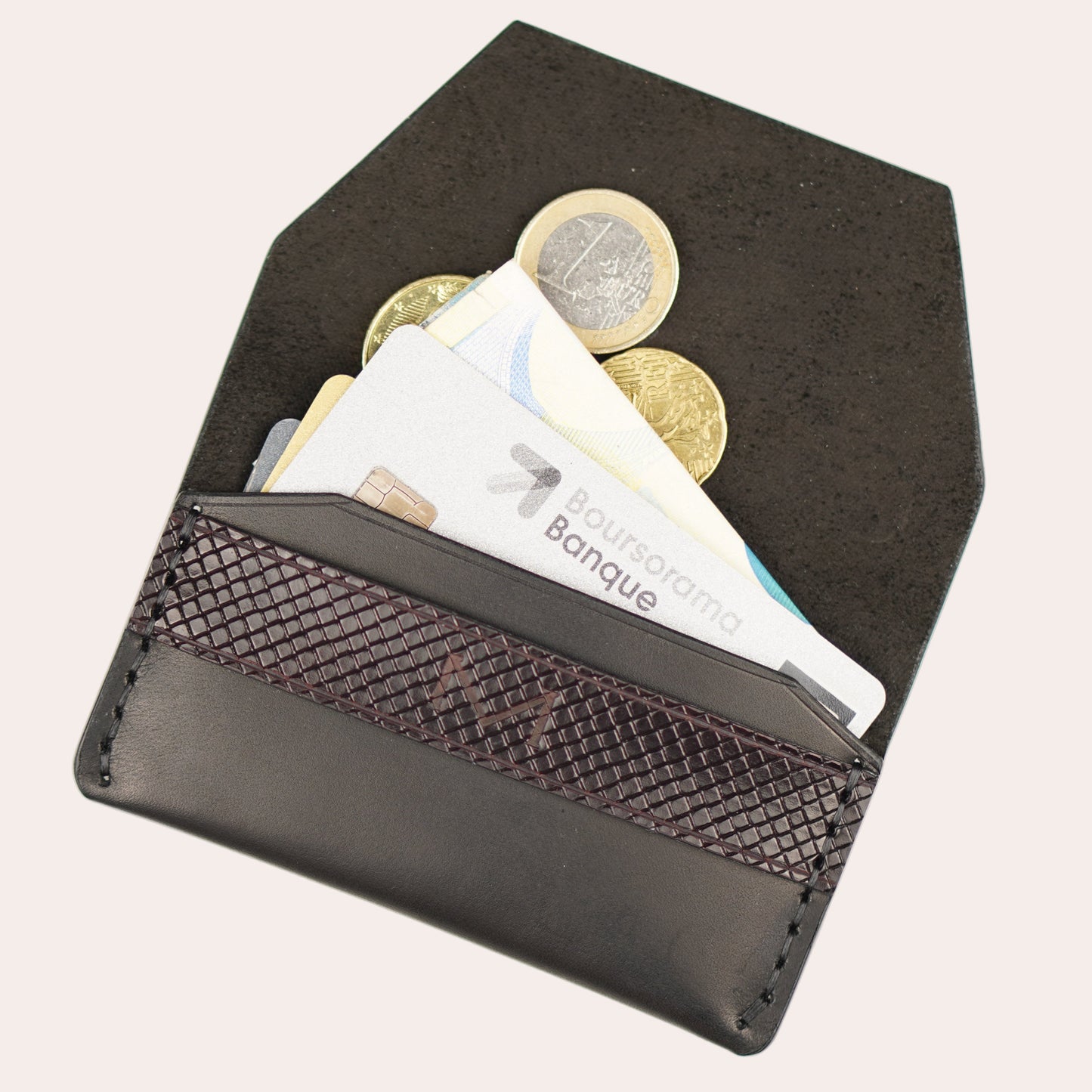 Black wallet with coins and banknotes on a white background