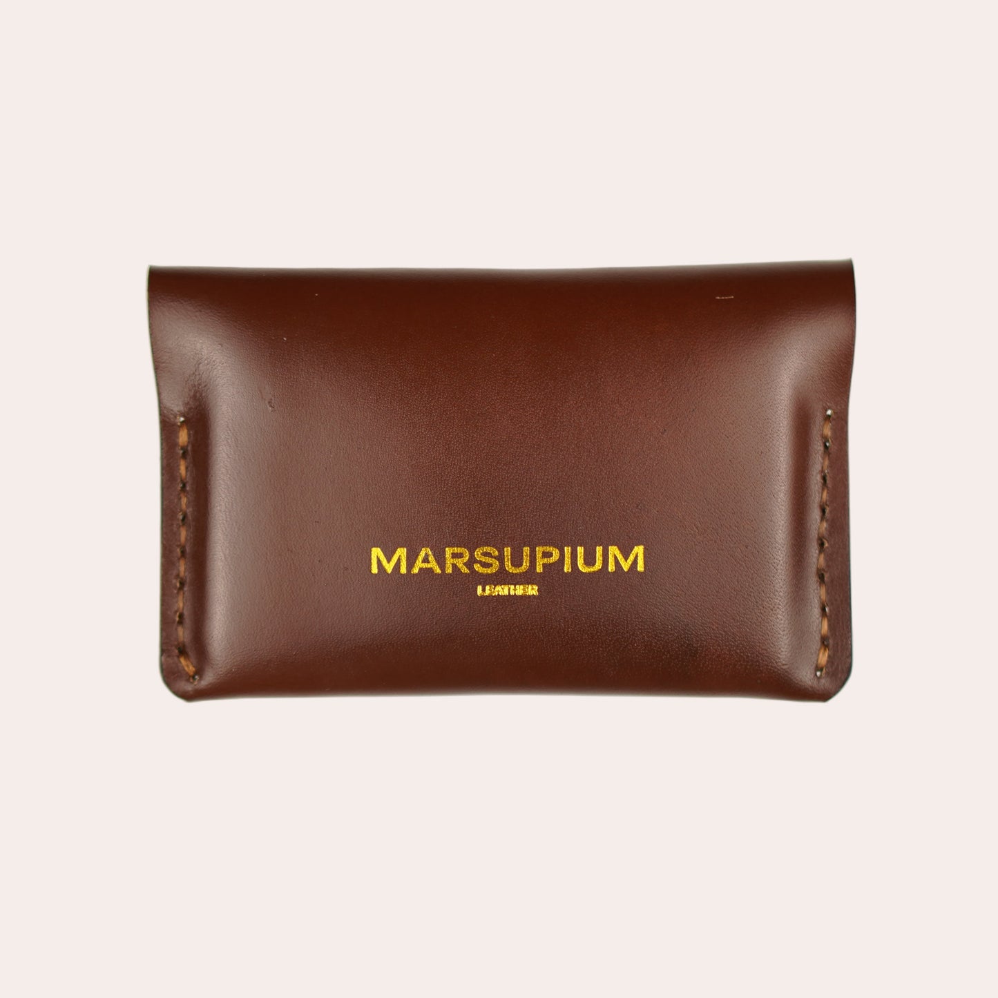 Brown leather pouch with 'MARSUPIUM' branding on a white background