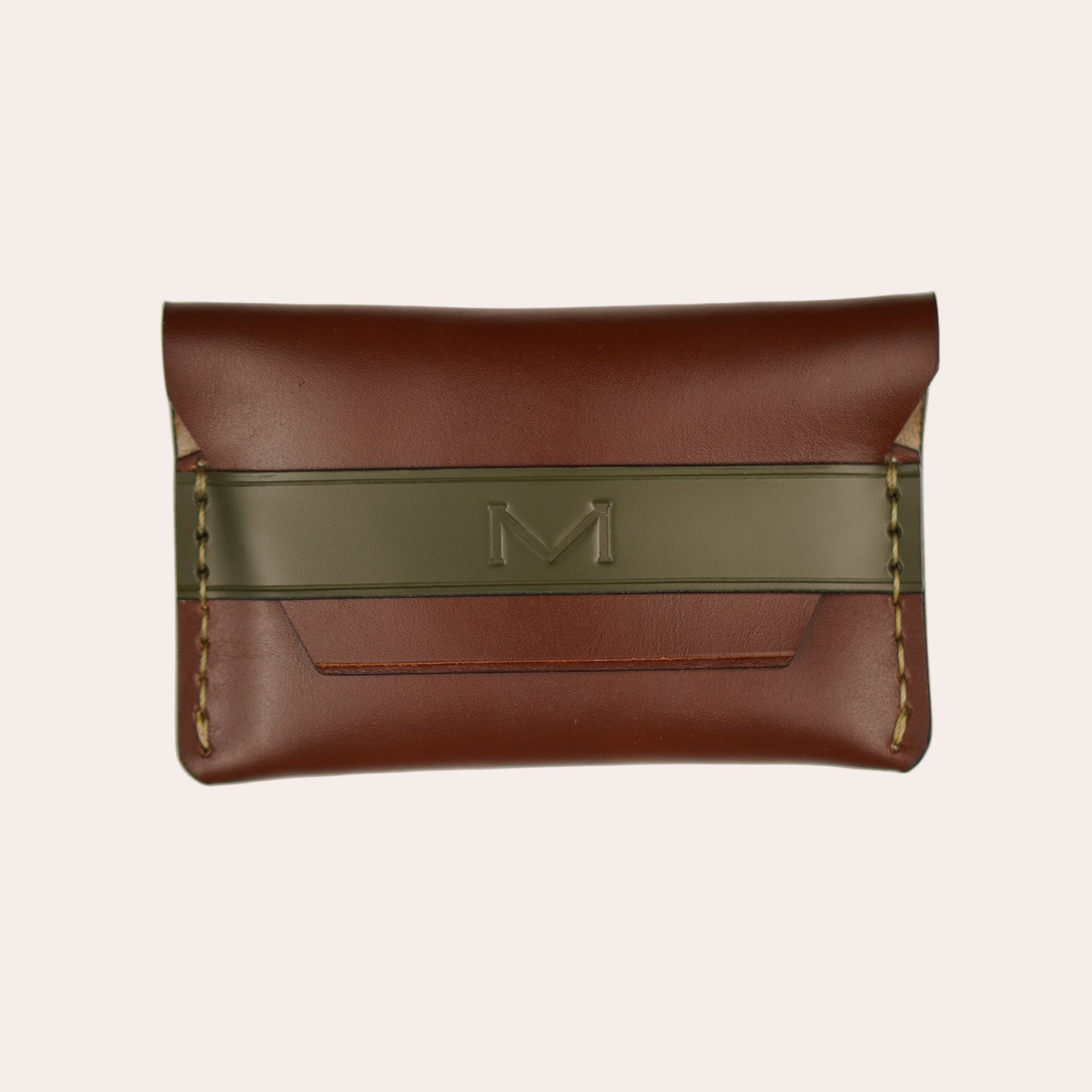 Brown leather wallet with a green strap on a white background