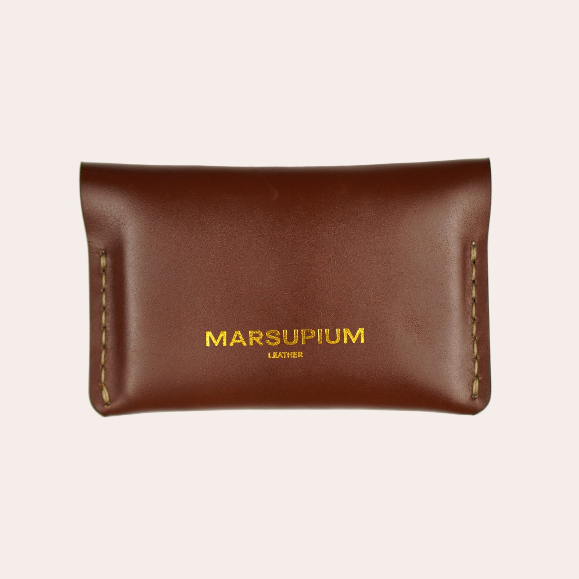 Brown leather pouch with 'MARSUPIUM' branding on a white background